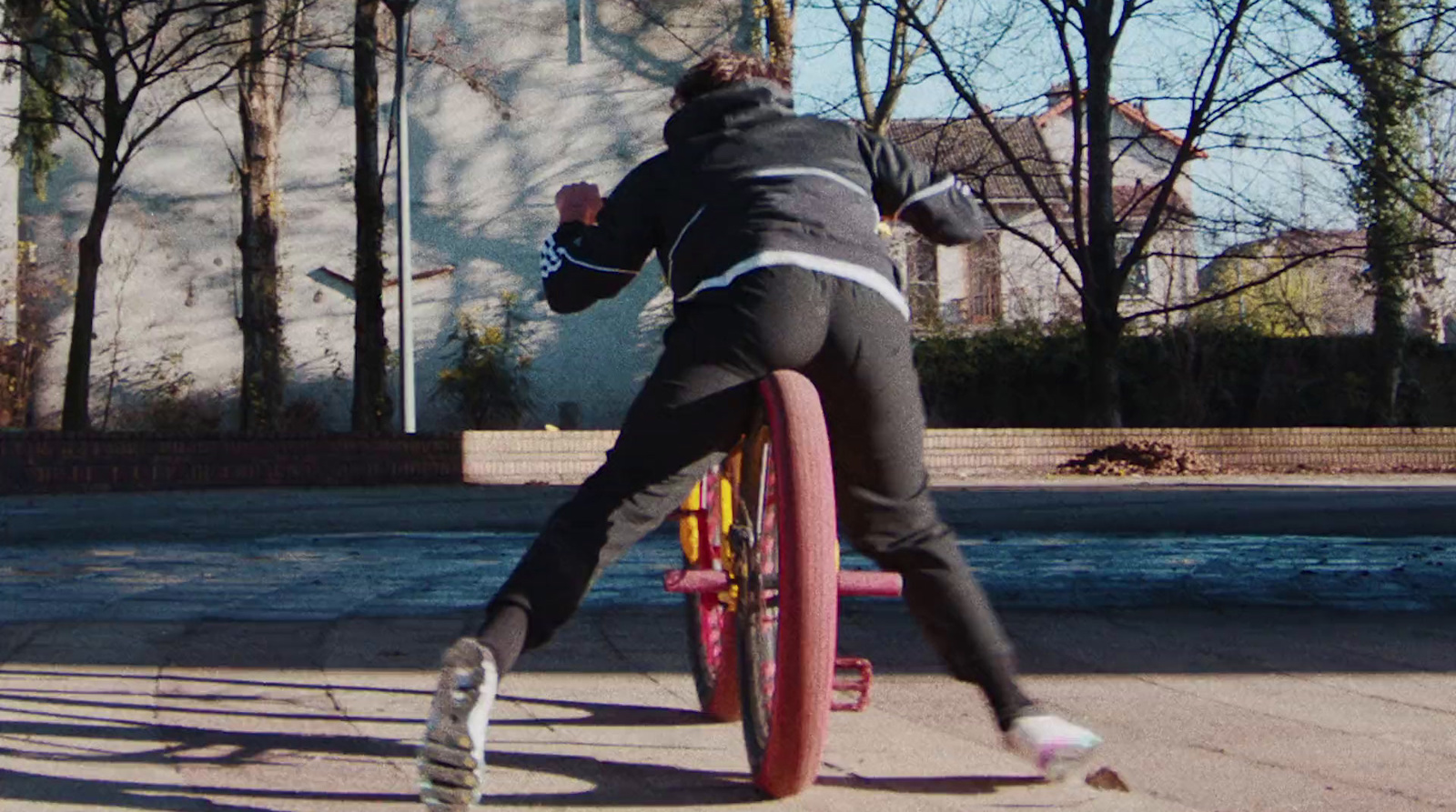 a person riding a bike on a city street