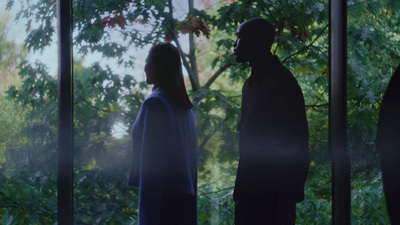 a man and a woman standing in front of a window