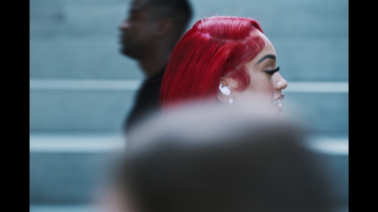 a woman with red hair and a black shirt