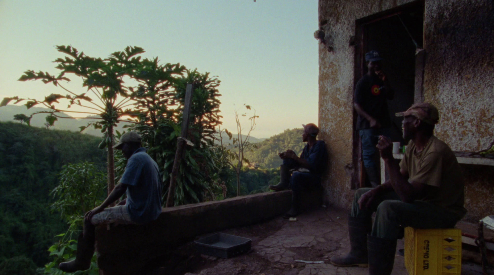 a group of men sitting on top of a building