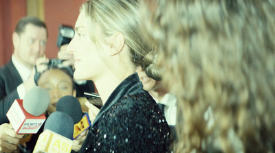 a woman talking to a man in a suit and tie