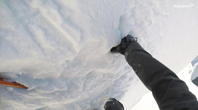 a person standing on a snow covered slope