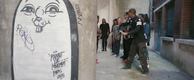 a group of people standing next to a building