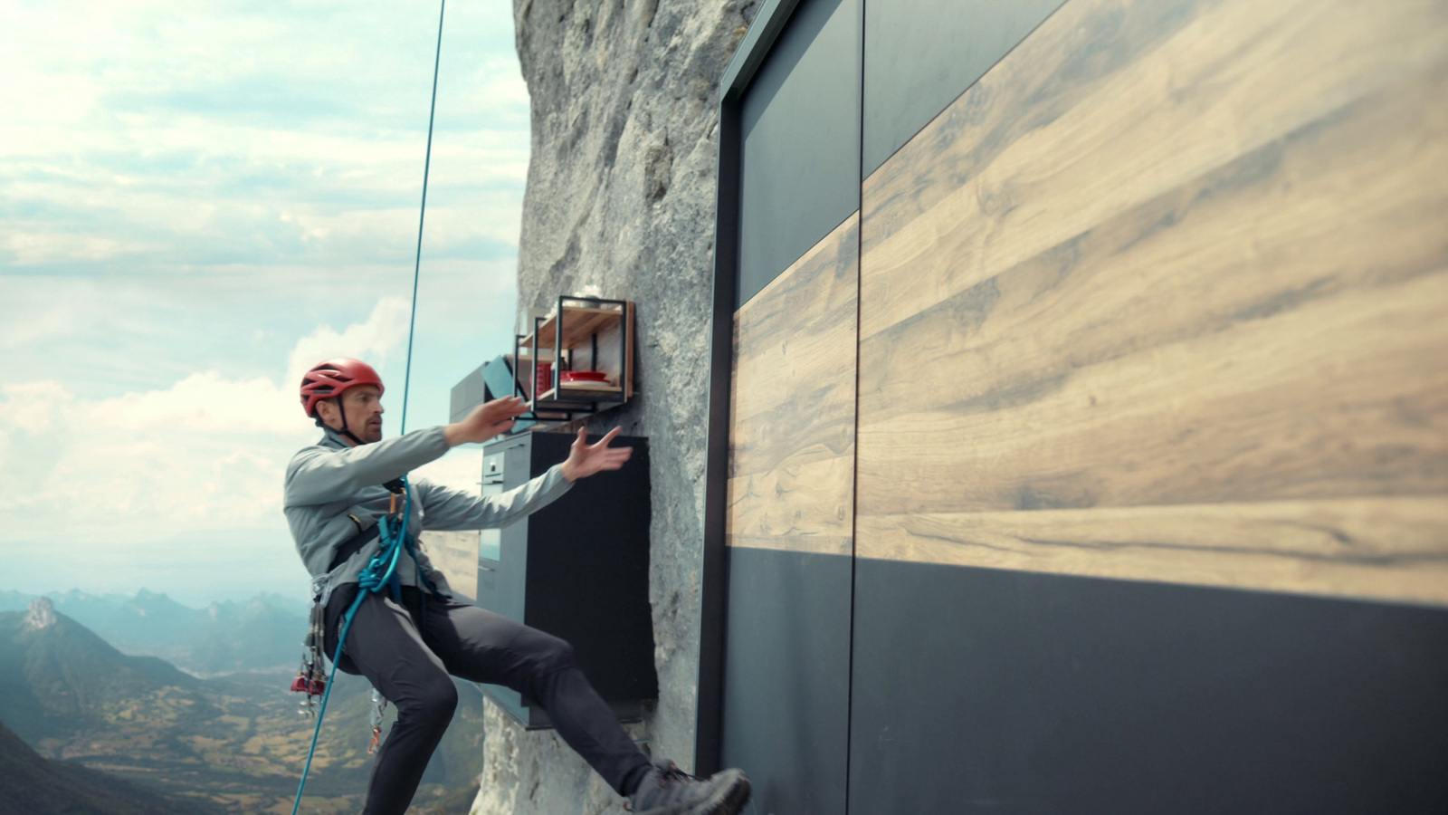 a man climbing up the side of a mountain