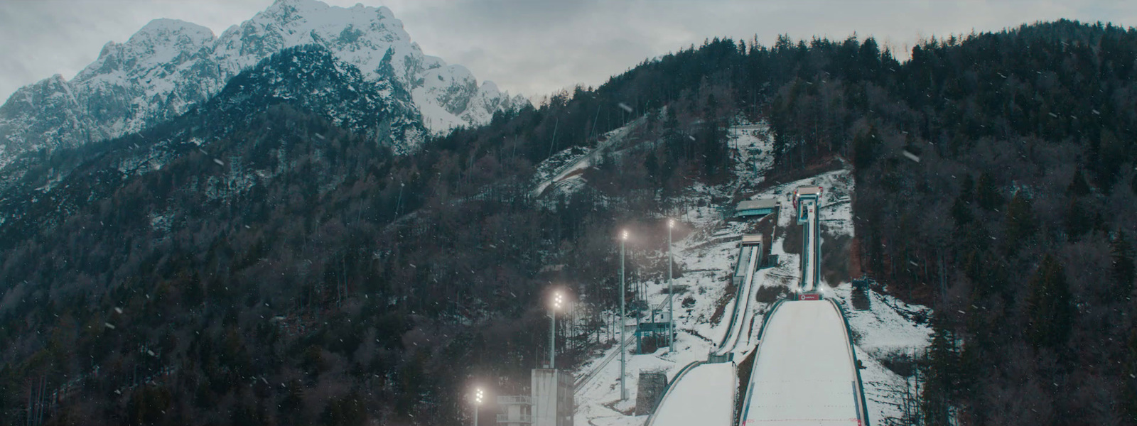 a snow covered mountain with a ski lift going down it