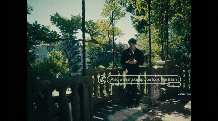 a man is standing on a bridge looking at his cell phone