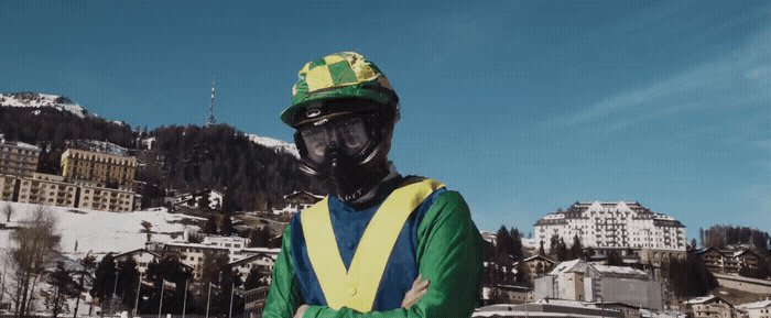 a man wearing a green and yellow jacket and helmet