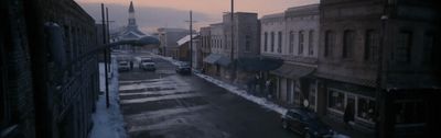 a view of a city street in the snow