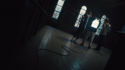 a group of people standing in a dark room