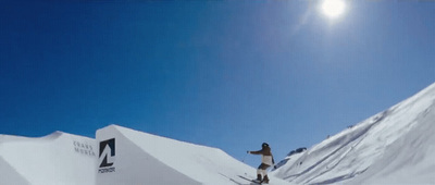 a man riding skis down the side of a snow covered slope