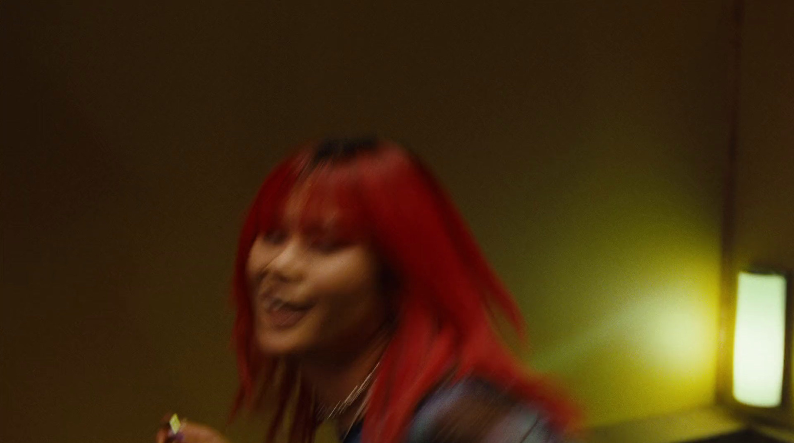 a woman with red hair holding a cell phone