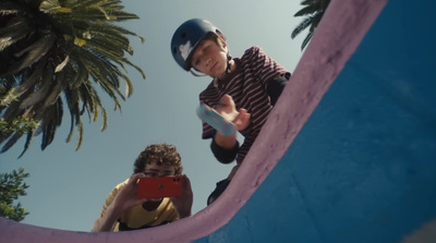 a young boy riding a skateboard up the side of a ramp