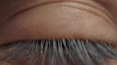 a close up of a person's eye with long eyelashes