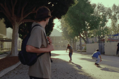 a group of people riding skateboards down a street