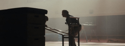 a woman sitting on a chair next to a stair case