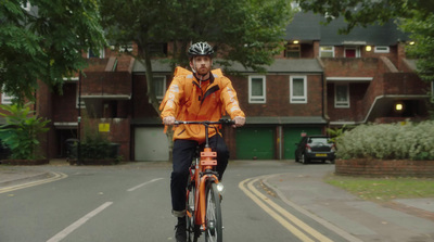 a man riding a bike down a street