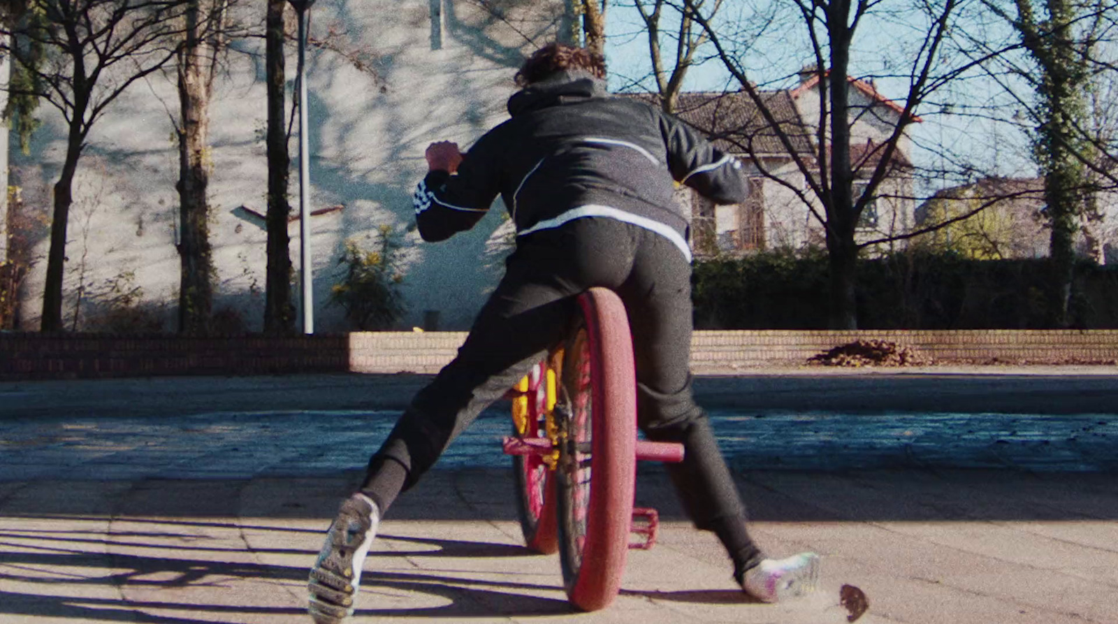 a person riding a bike on a city street