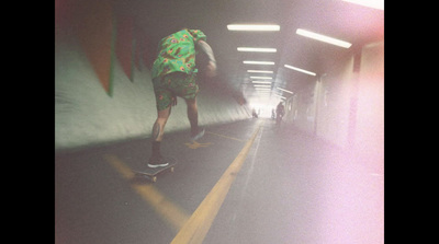 a man riding a skateboard down a tunnel