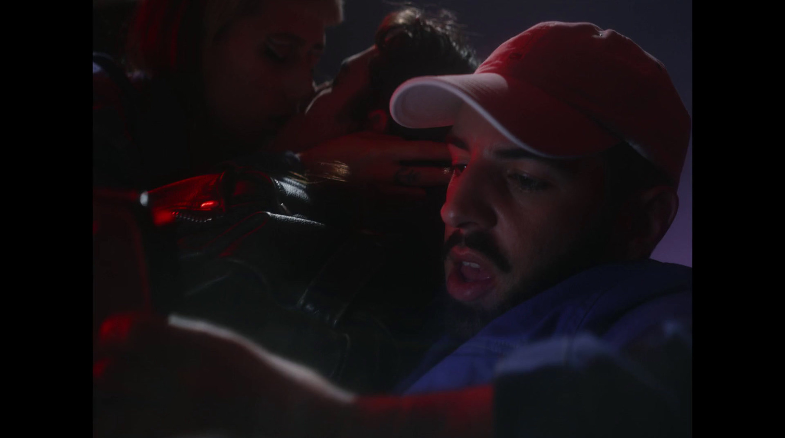 a man in a red hat is looking at his cell phone