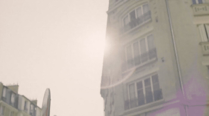 a street sign in front of a tall building