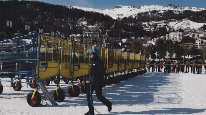 a man riding skis down a snow covered slope