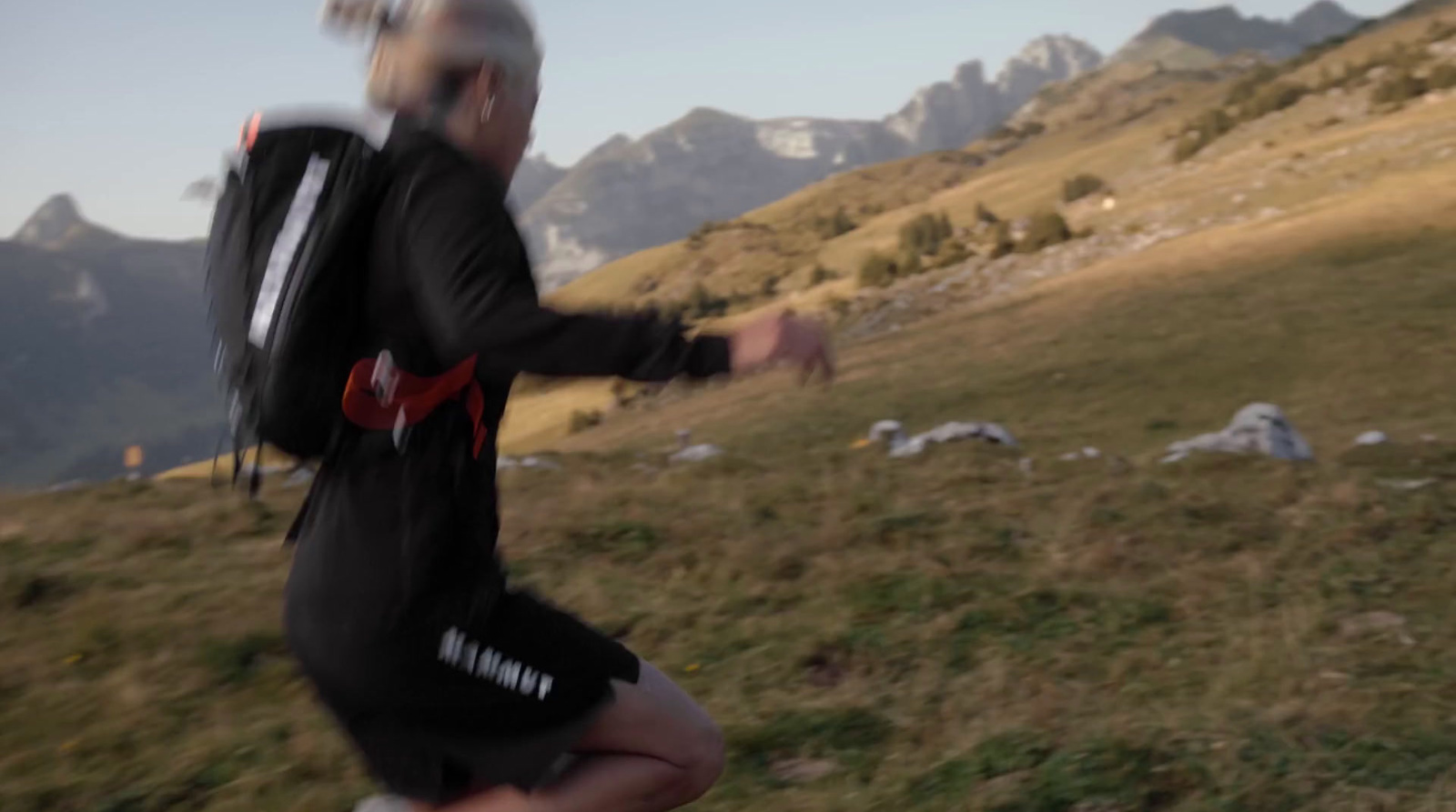 a man with a backpack running up a hill