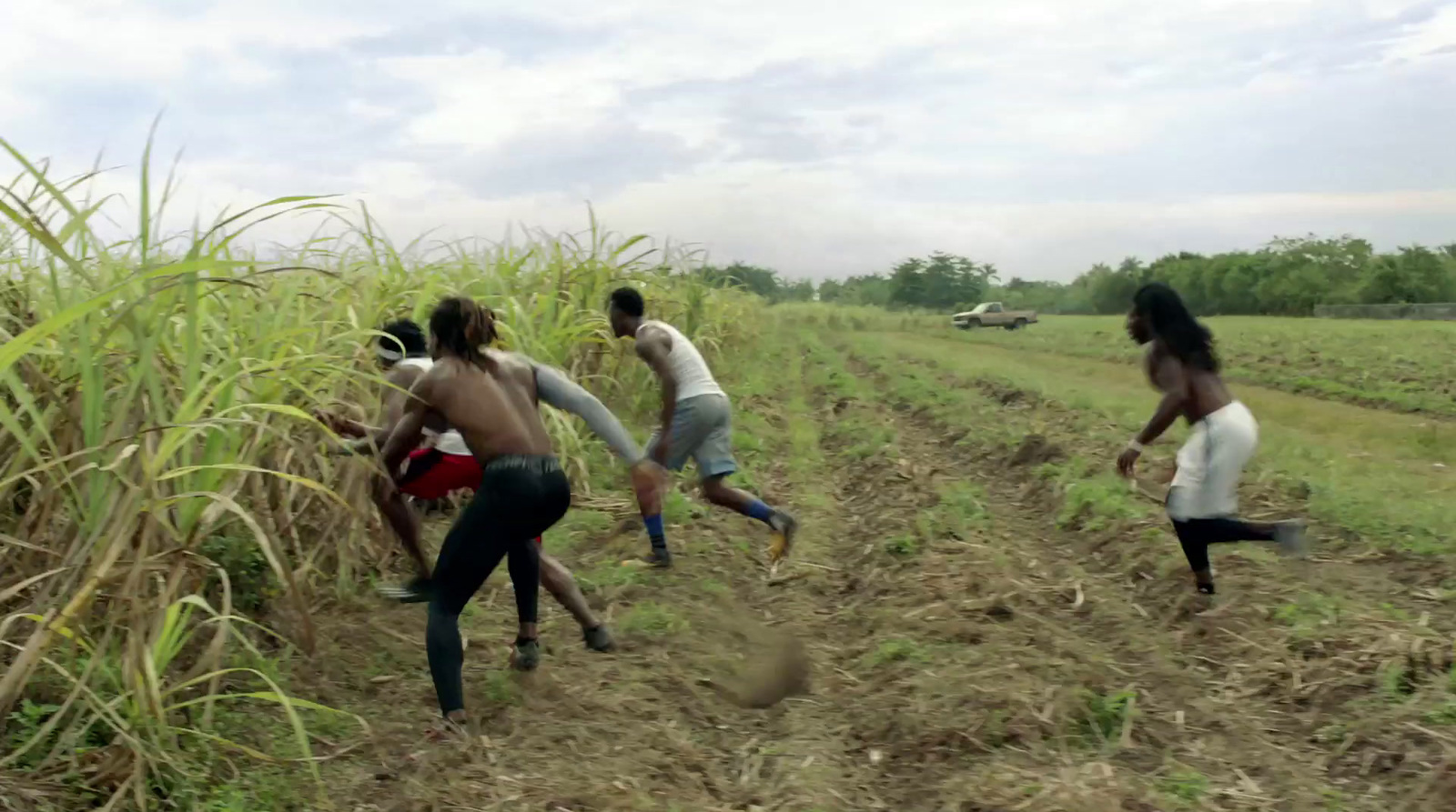 a group of people running through a field