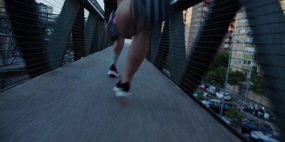 a man riding a skateboard across a bridge