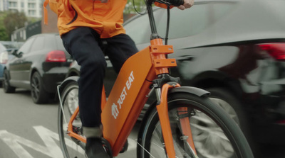 a person riding a bike on a city street