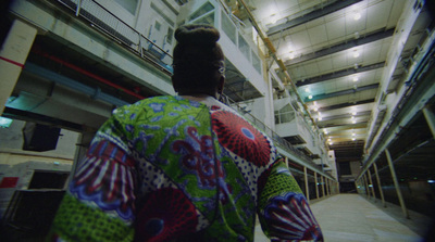 a man in a colorful shirt standing in a building