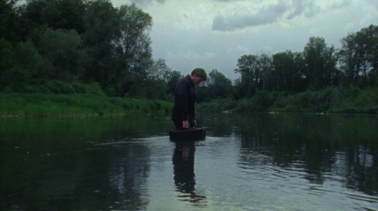 a man standing on a boat in a river