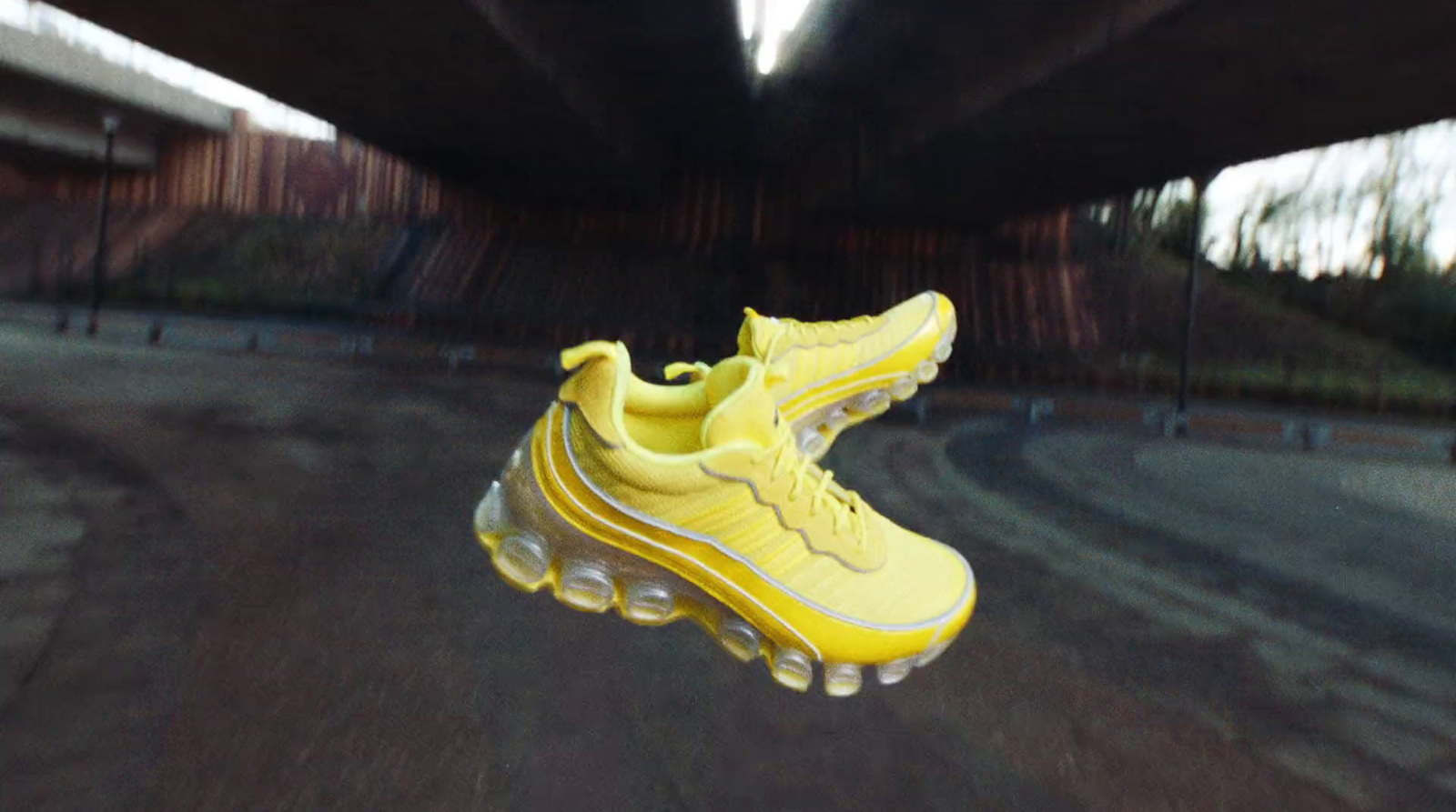 a pair of yellow shoes hanging from a ceiling