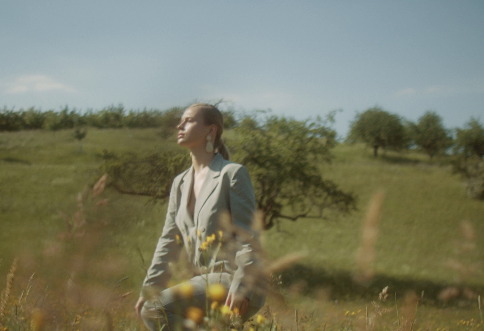 a woman standing in a field of flowers