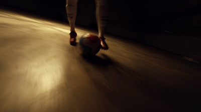 a person riding a skateboard down a street at night