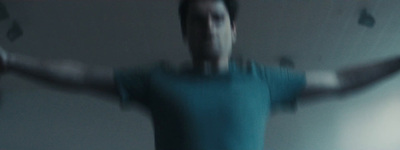 a blurry image of a man in a blue shirt