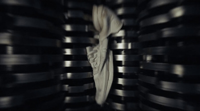 a pair of white sneakers sitting on top of a metal shelf