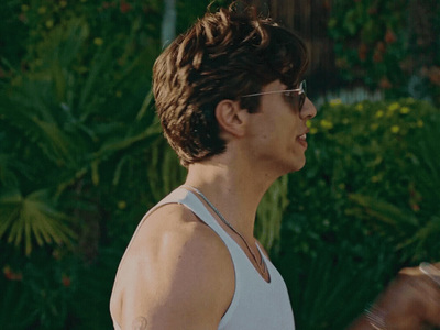 a man wearing glasses and a tank top