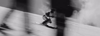 a man riding skis down a snow covered slope