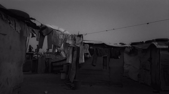 a black and white photo of clothes hanging on a line