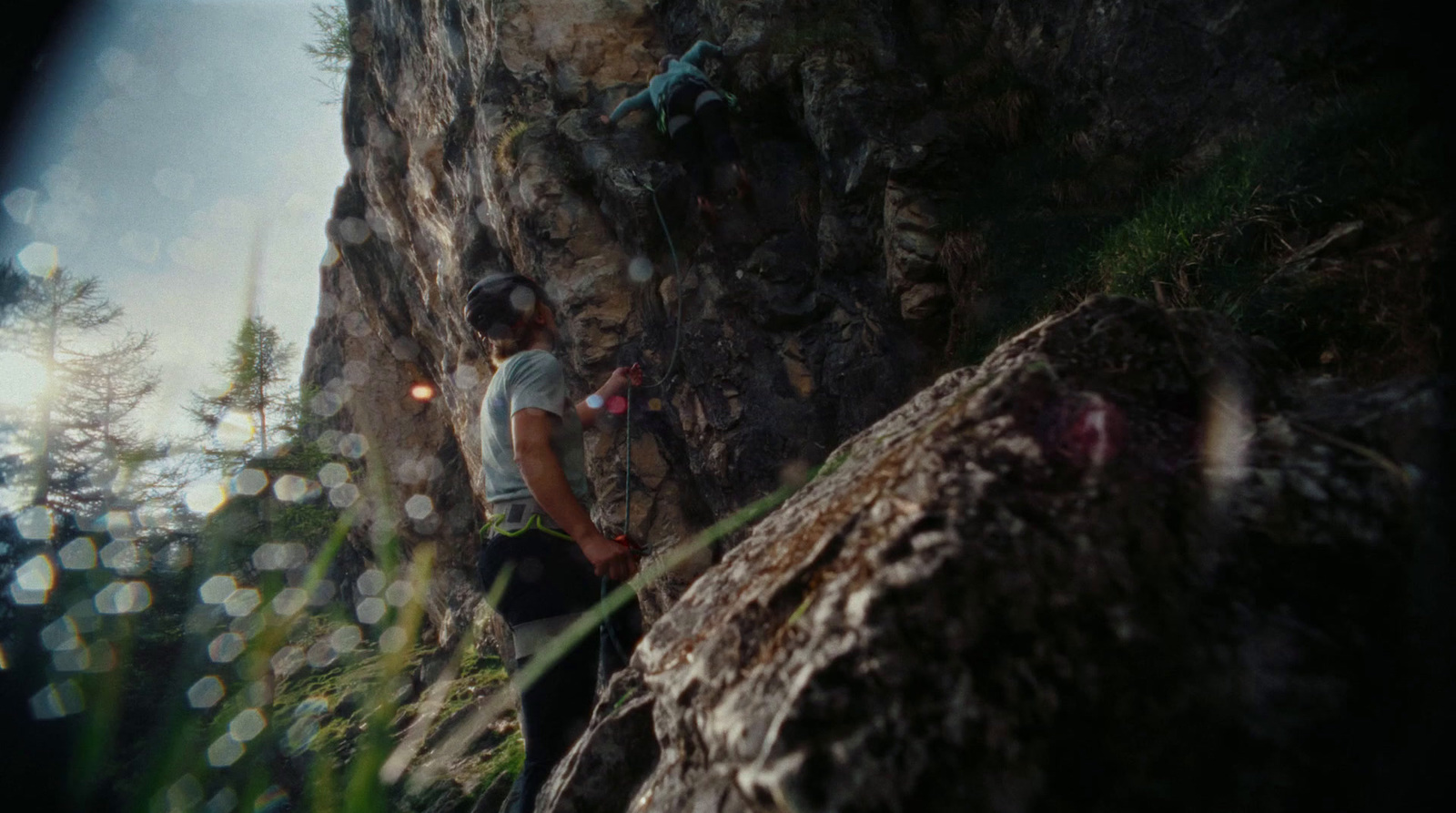 a man climbing up the side of a mountain