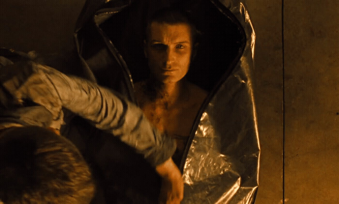 a man with no shirt in a metal bag