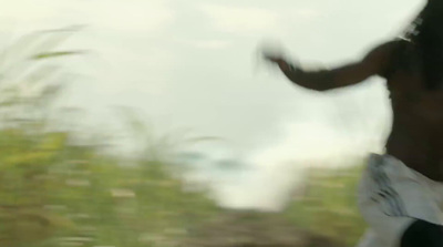 a blurry image of a man holding a surfboard