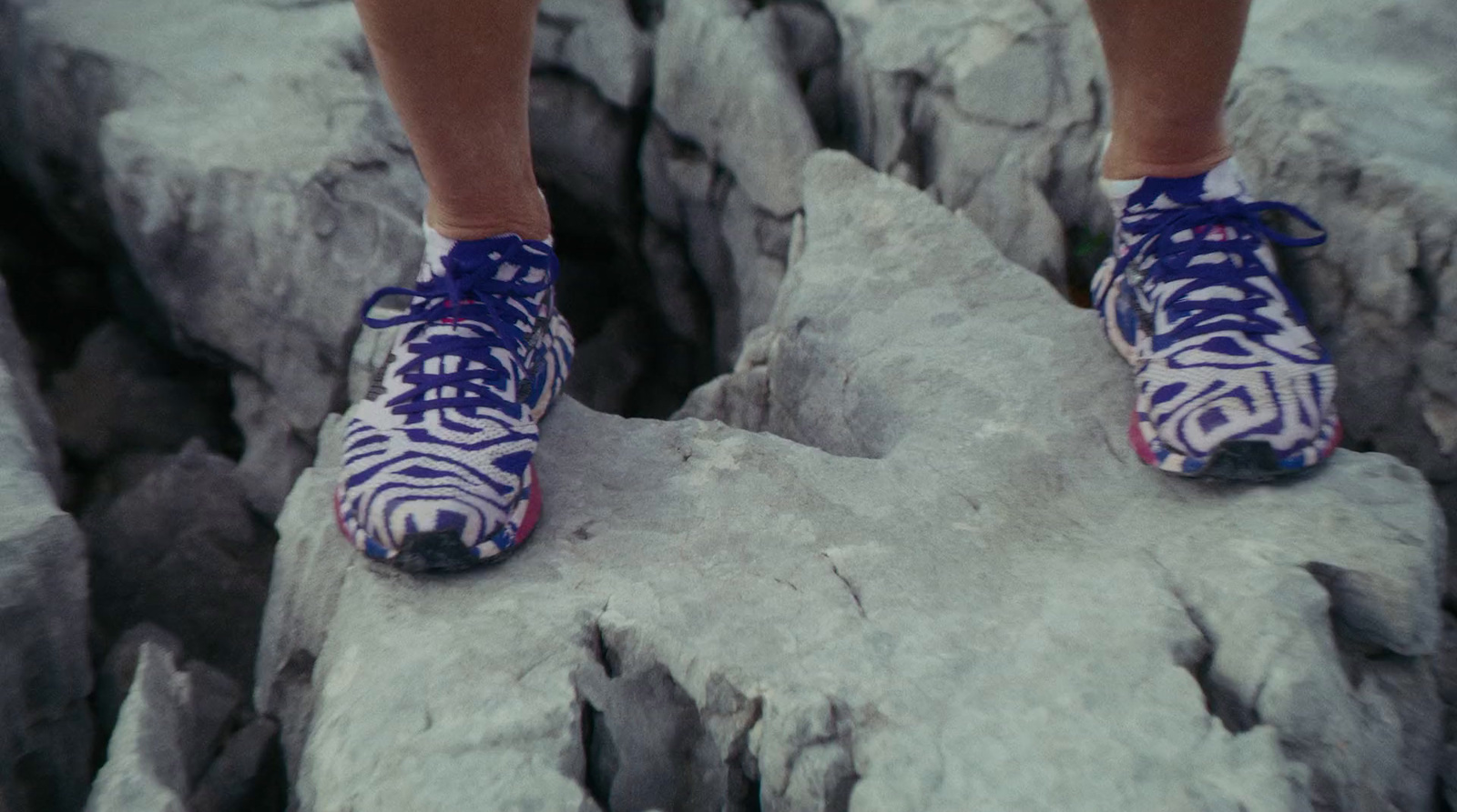 a person standing on top of a rock formation