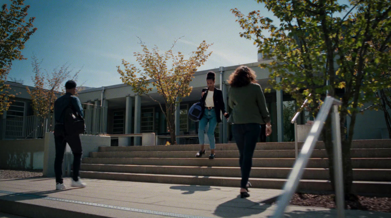 a group of people walking up some steps