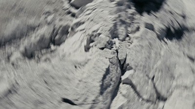 a black and white photo of a rock formation