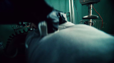 a hospital room with a bed and a monitor