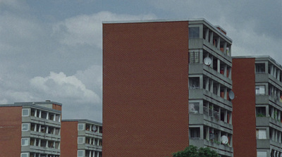 a tall brick building with a clock on it's side