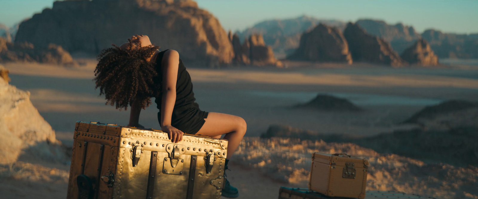 a woman sitting on top of a wooden crate