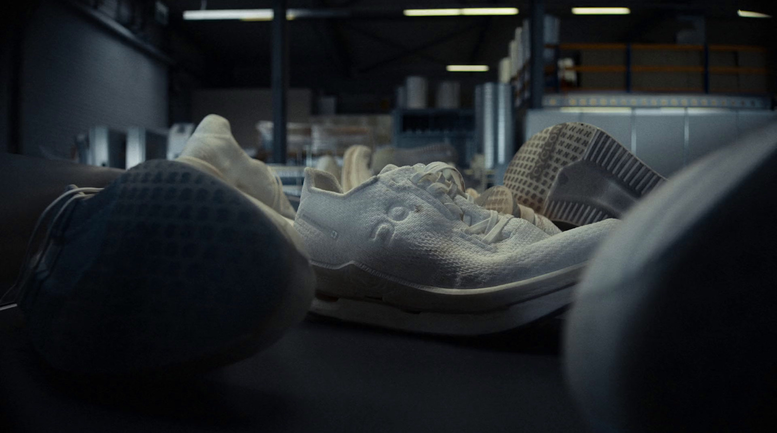 a pair of white shoes sitting on top of a floor