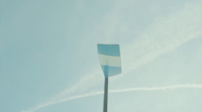 a blue and white flag flying in the sky